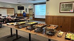 Lunch and learn food table with presentation in background
